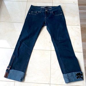 Dark jeans with cuffs in the legs.